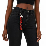 Porte-clé en tissu Coo-Mon accroché à un jean noir porté, accessoire pratique et stylé au quotidien, Québec