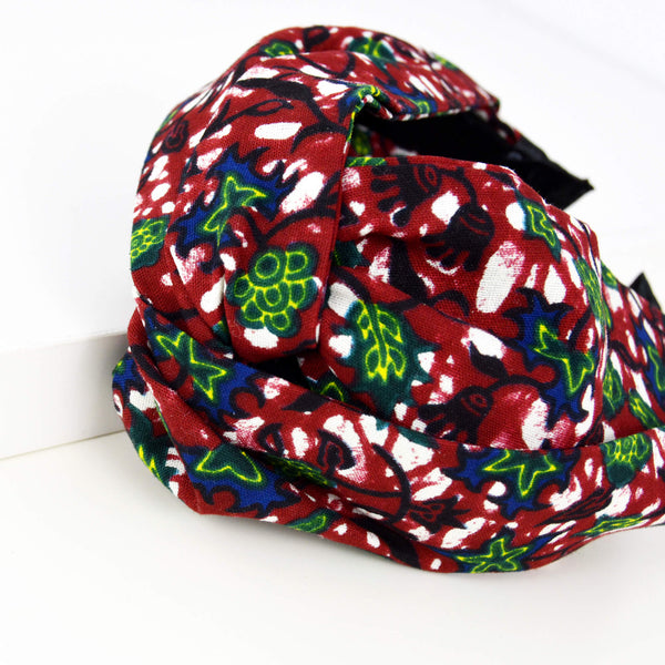 red twiss cross headband with green and blue leaves pattern