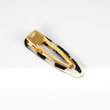 Teardrop resin hair barette with a piece of african print fabric scrap and gold glitter