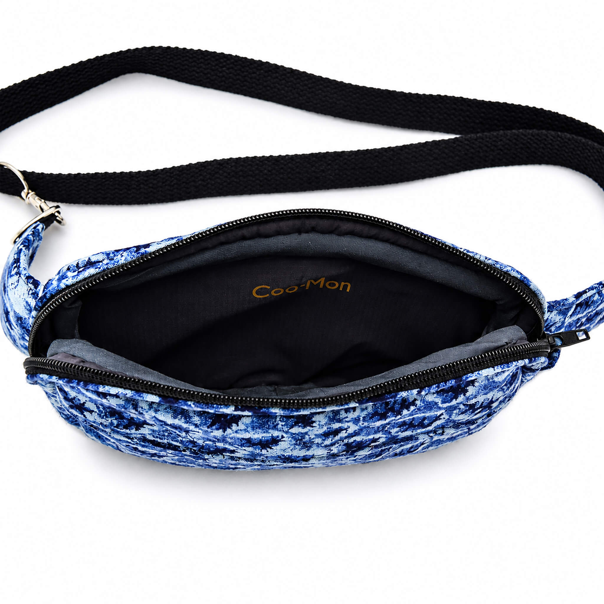 Intérieur du sac bandoulière bleu en tissu recyclé avec compartiment principal zippé.
