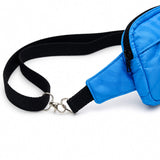 Gros plan de la sangle noire ajustable et des attaches métalliques d'un sac bandoulière convertible en bazin turquoise.
