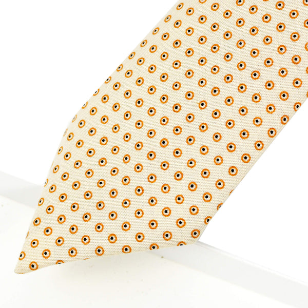 Cravate beige à pois cerclés dorés et points noirs